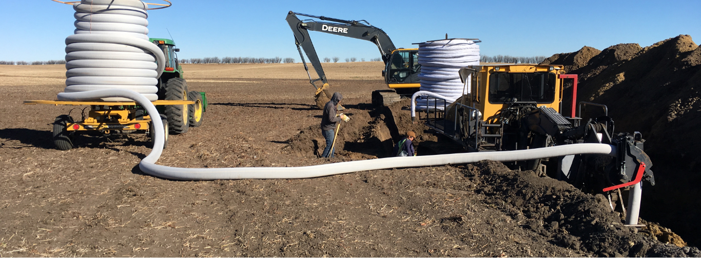 Two People performing Tile Drainage Services in Saskatchewan, Canada