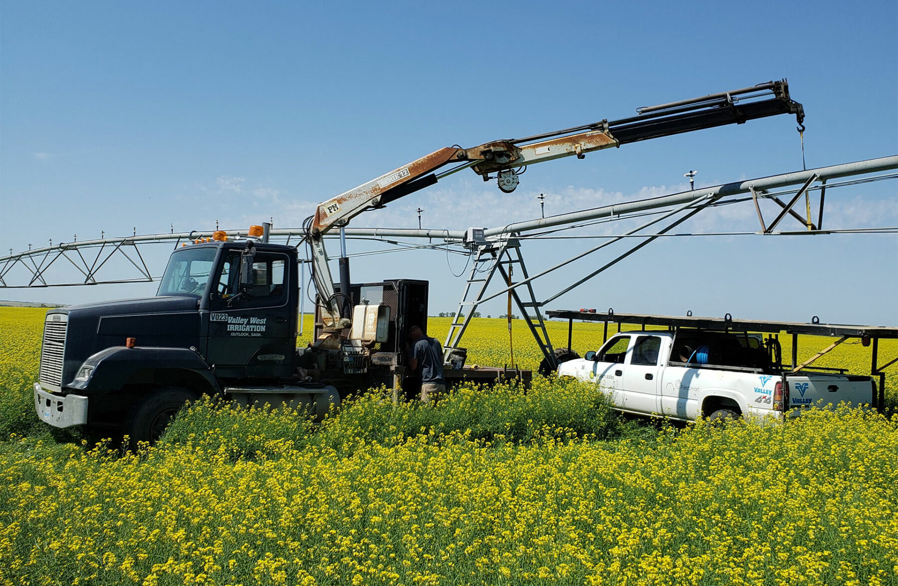 Western Water Management Service Truck Performing Irrigation Maintenance in a Field in Saskatchewan, Canada
