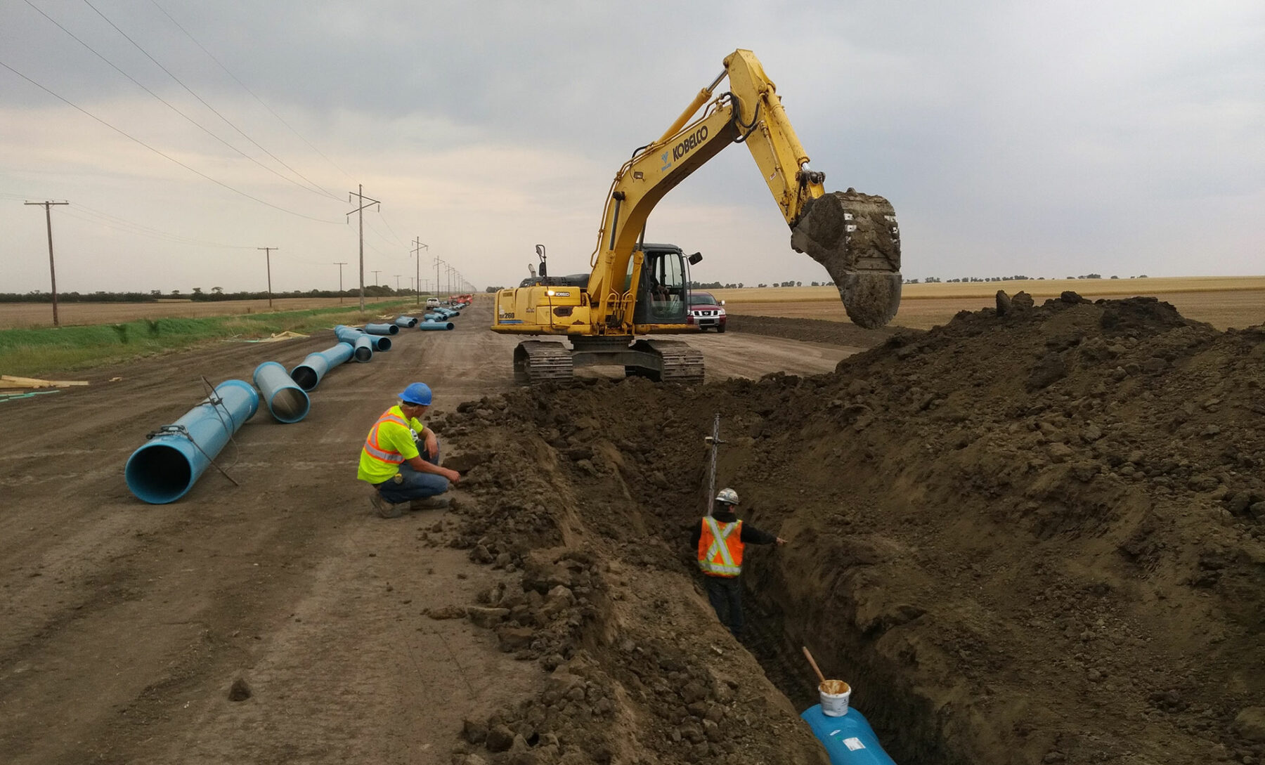 Two workers Trenching for Western Water Management